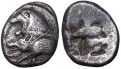 Karia, uncertain mint. AR Stater. Circa 500 BC. Forepart of lion with open jaws standing left before sunburst; in front, forepart of boar with legs extended left / Irregular rough incuse markings. 9.9