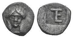Ionia, Kolophon AR Tetartemorion. Ionia, Kolophon AR Tetartemorion. c. 450-410. Facing head of Apollo / Monogram (mark of value) within incuse rectangle. Milne, Colophon 7; Klein 398. 0.23g, 7mm, 5h. 