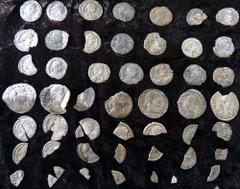 Hoard of 6 Miliarenses, 15 Siliquae and 31 assorted fragments. Found near Thruxton, Hampshire, over several days during the course of August 2014. Many of the coins are buckled and fragmentary; probab