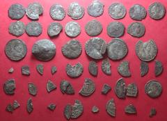 Hoard of 6 Miliarenses, 15 Siliquae and 31 assorted fragments. Found near Thruxton, Hampshire, over several days during the course of August 2015. Many of the coins are buckled and fragmentary; probab