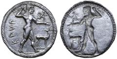Greek Bruttium, Kaulonia AR Stater. Circa 525-500 BC. Nude Apollo walking right, holding laurel branch in upright right hand, small daimon running to right on Apollo's extended left arm, wearing chlam