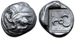 Greek Dynasts of Lycia, Tnnemi AR Stater. Circa 460-450 BC. Griffin crouching to left, right forepaw raised, linear symbol above; all on round shield / Triskeles, TΞN↑ME around; all within dotted bord